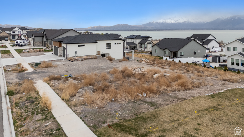 View of yard with a residential view, an attached garage, and driveway