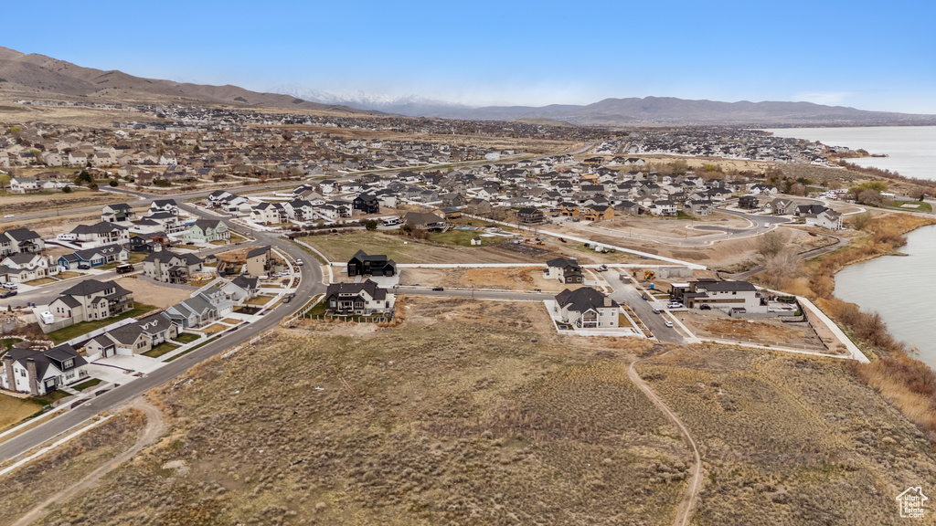 Aerial overview of property's location featuring a water and mountain view and nearby suburban area