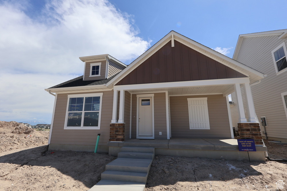 View of front of home with covered porch and board and batten siding