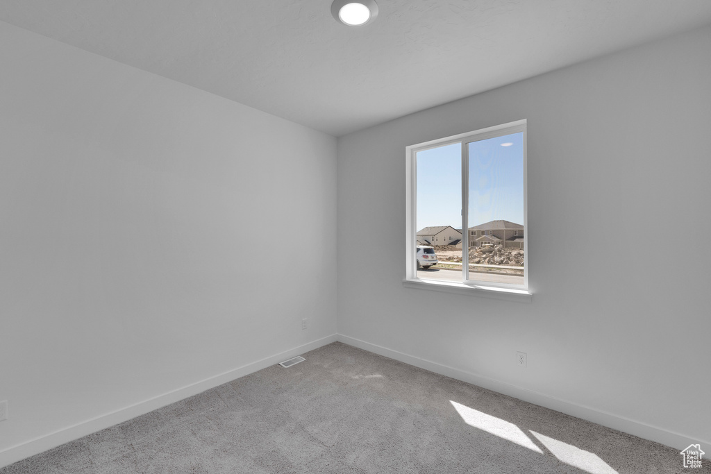 Empty room with baseboards and carpet floors