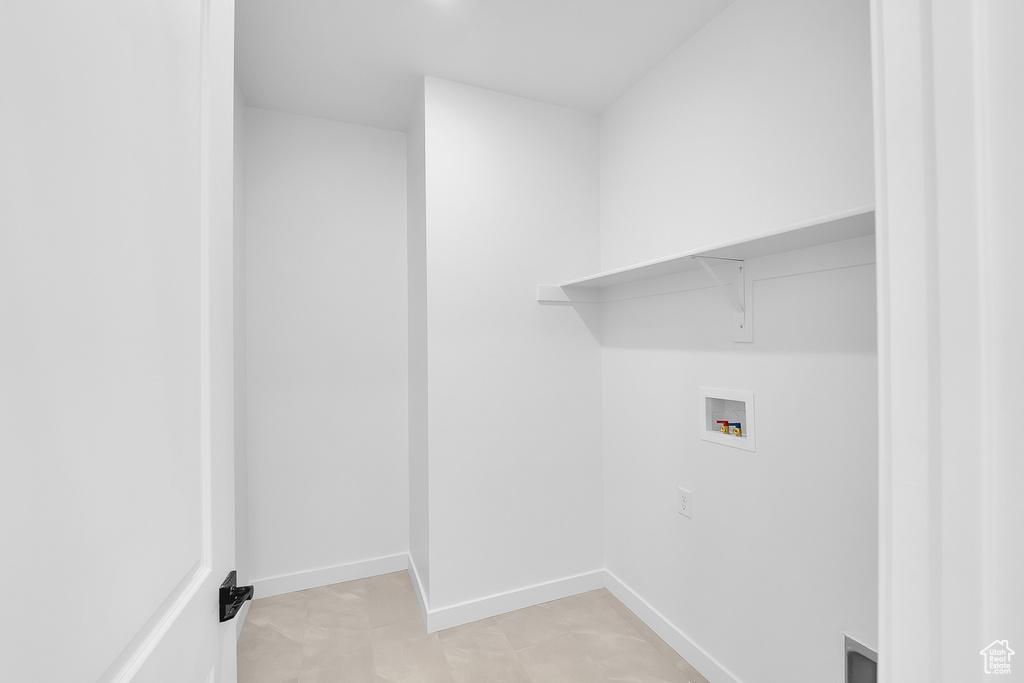 Laundry area featuring washer hookup, baseboards, and attic access