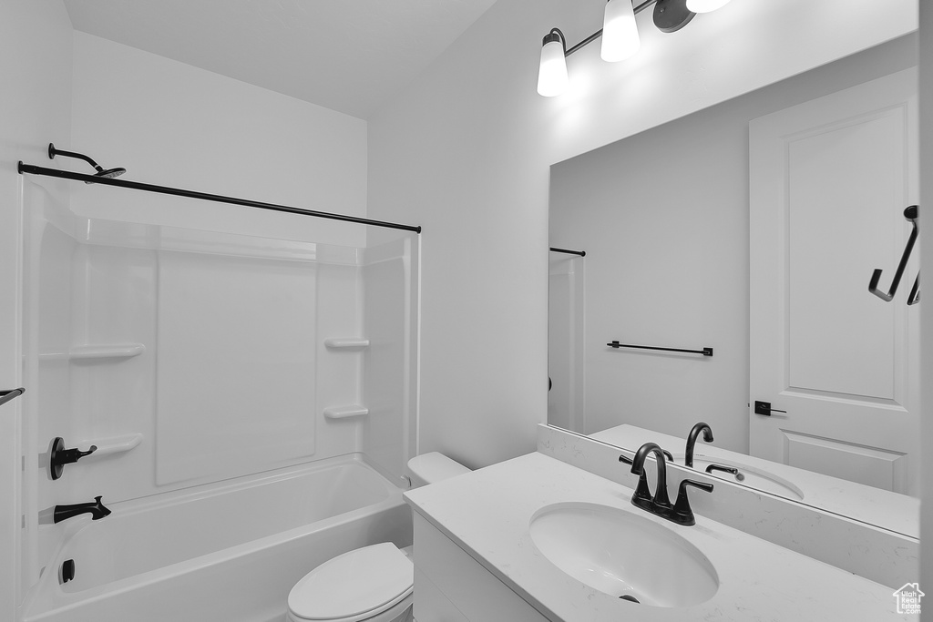Bathroom featuring vanity, toilet, and tub / shower combination