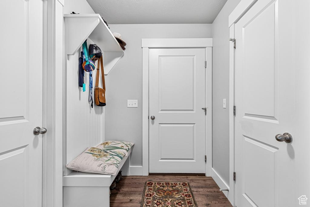 Mudroom with wood finished floors and baseboards