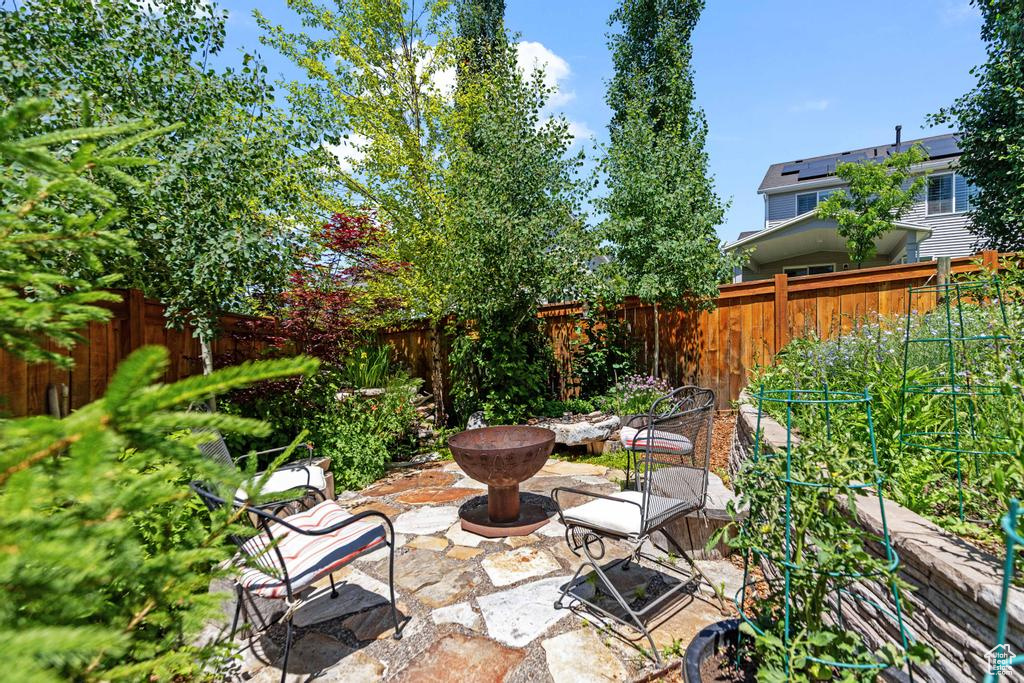 Fenced backyard featuring a patio area and a fire pit
