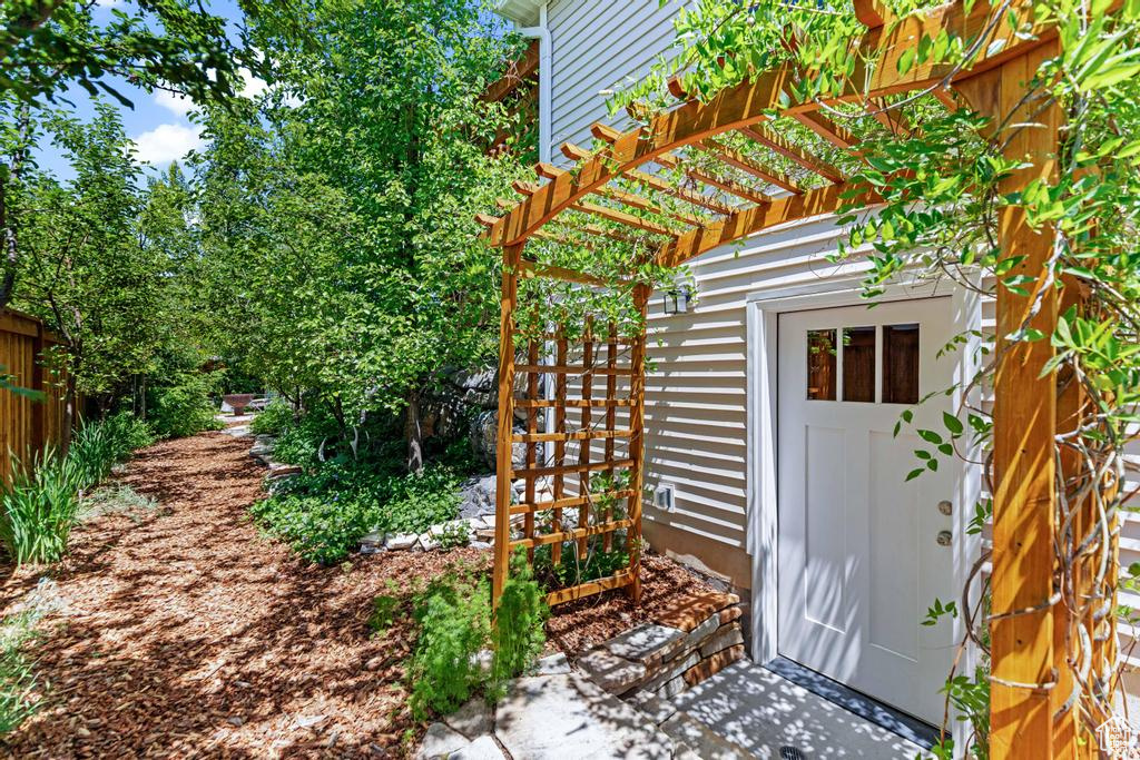 Property entrance featuring a pergola