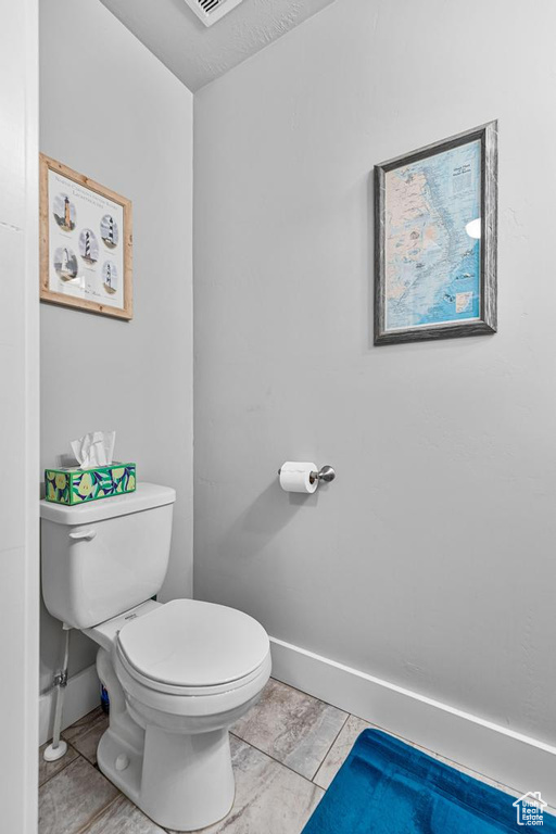 Bathroom featuring baseboards and toilet