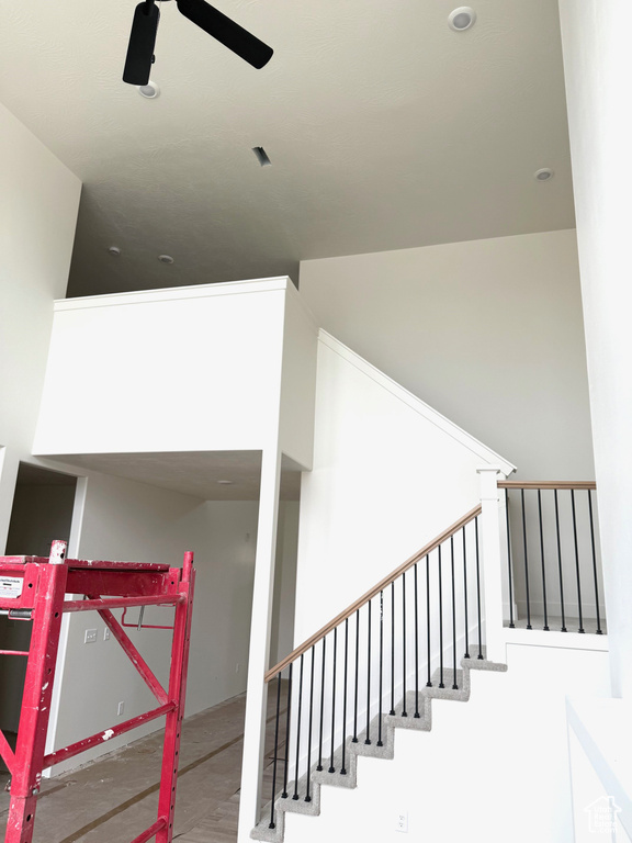 Staircase featuring ceiling fan