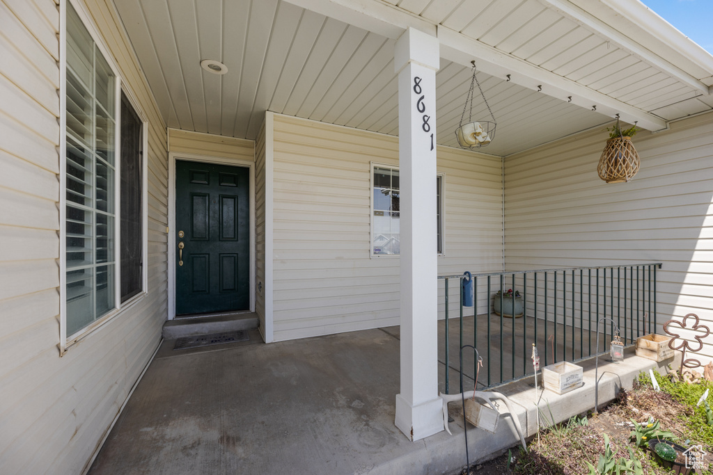 Entrance to property featuring covered porch