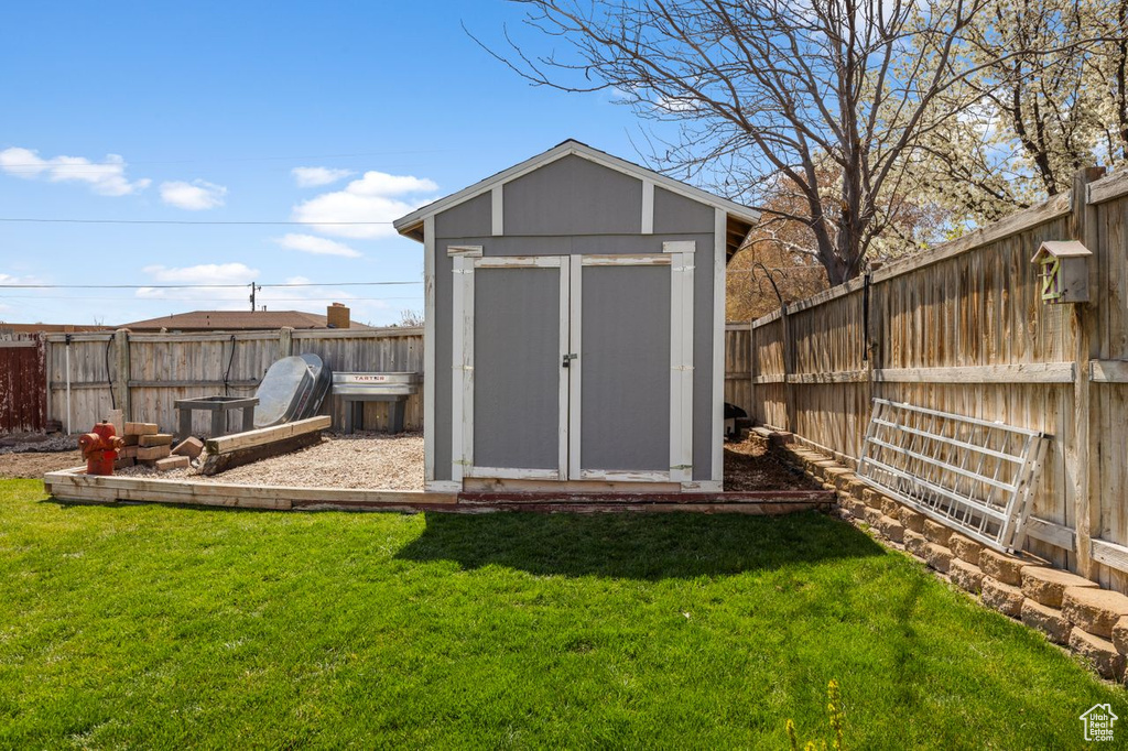 View of shed featuring a fenced backyard