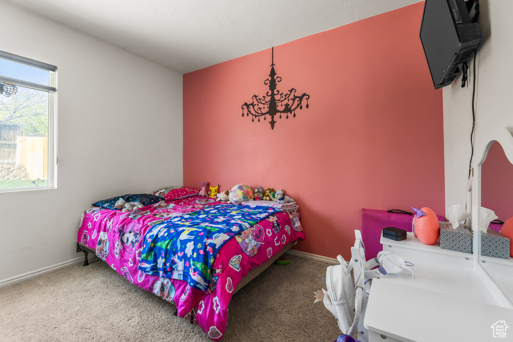 Carpeted bedroom featuring baseboards