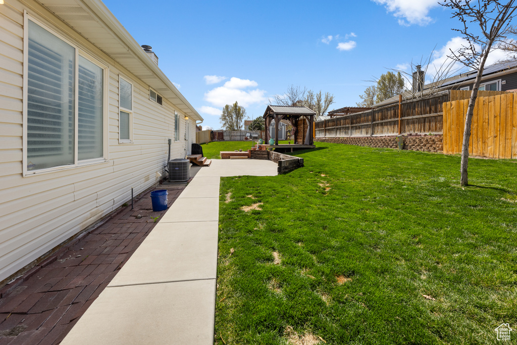 View of yard with a fenced backyard and a patio