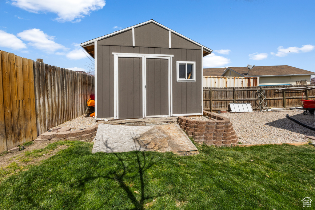 View of shed featuring a fenced backyard