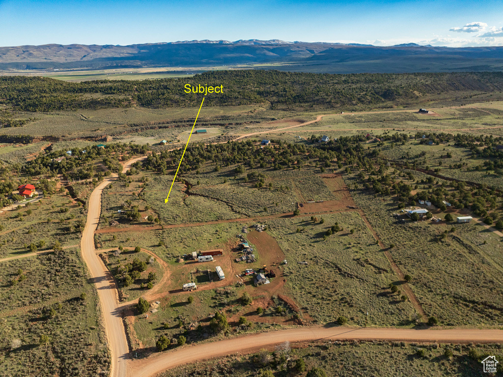 Birds eye view of property with a mountain view and a rural view
