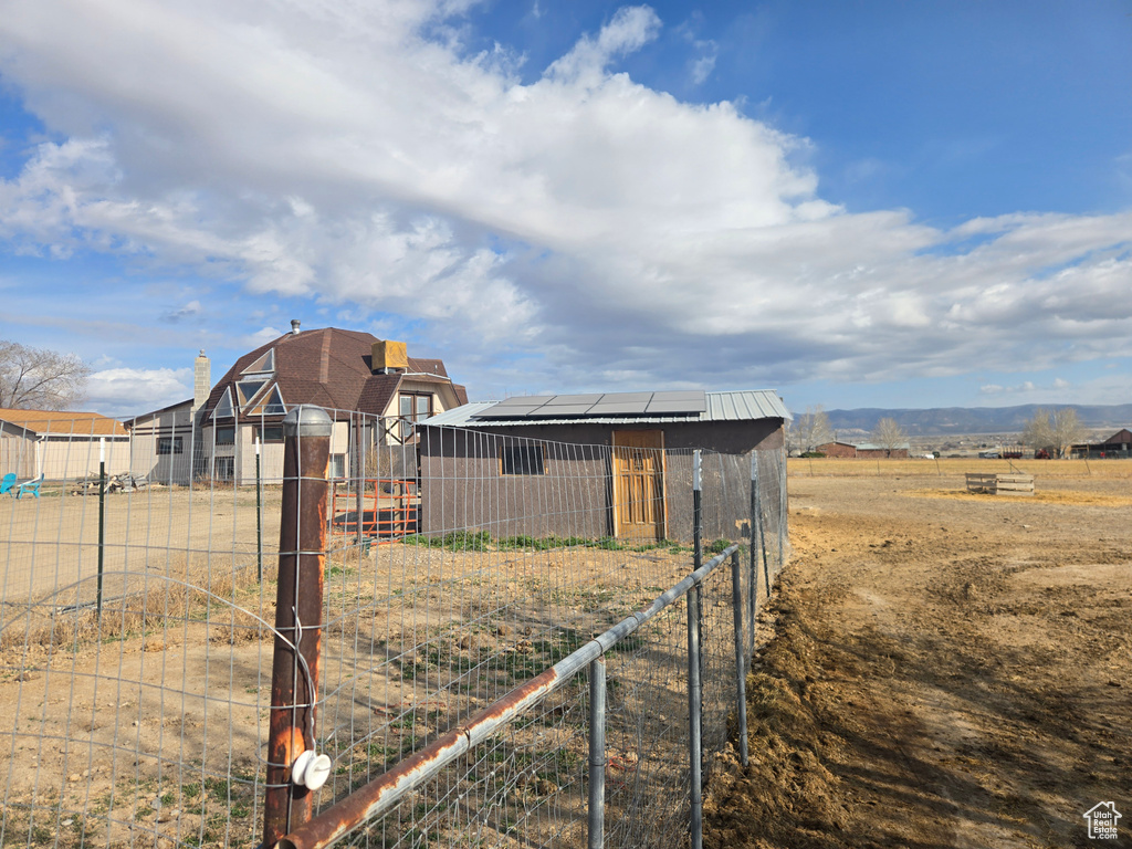View of yard featuring an outbuilding and fence
