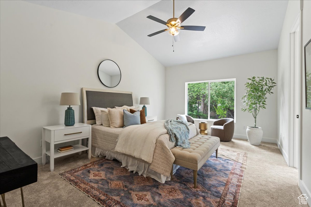 Bedroom featuring carpet floors, vaulted ceiling, baseboards, and ceiling fan