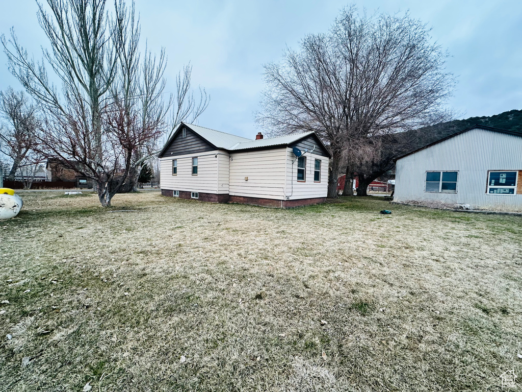 Exterior space with a yard and metal roof