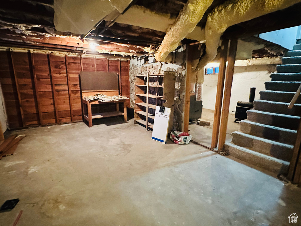 Unfinished below grade area featuring stairs