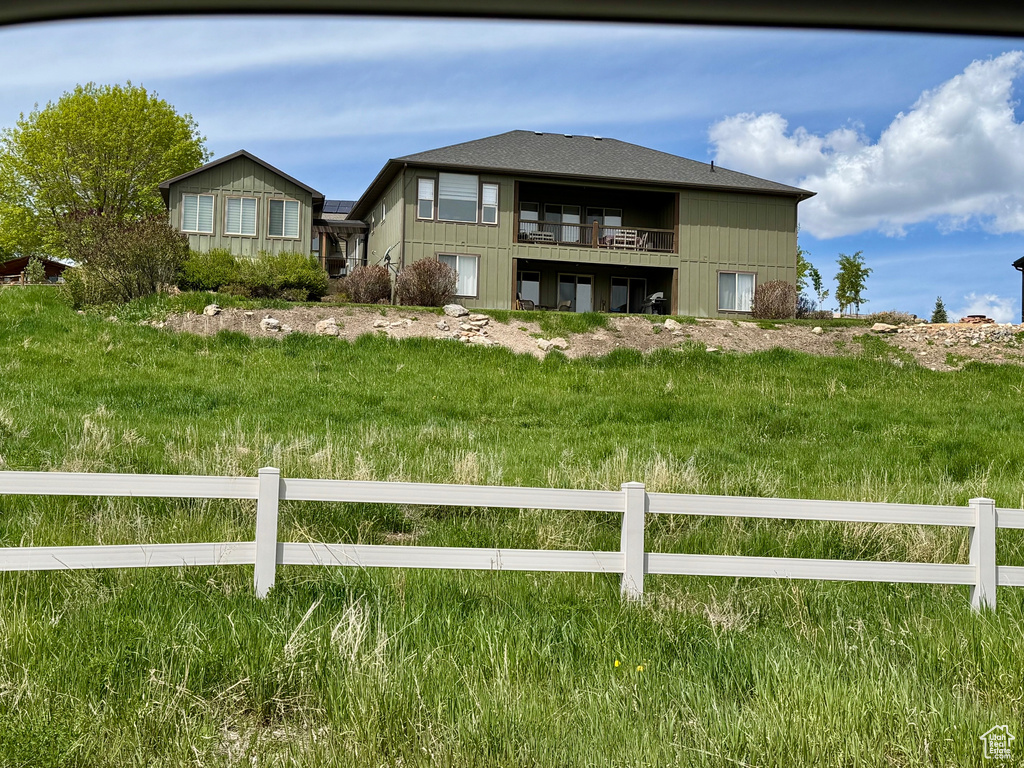 Back of property with a balcony