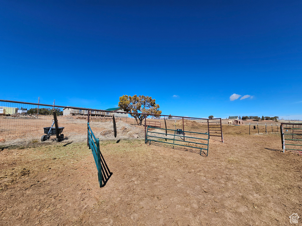 View of home's community featuring fence and a rural view