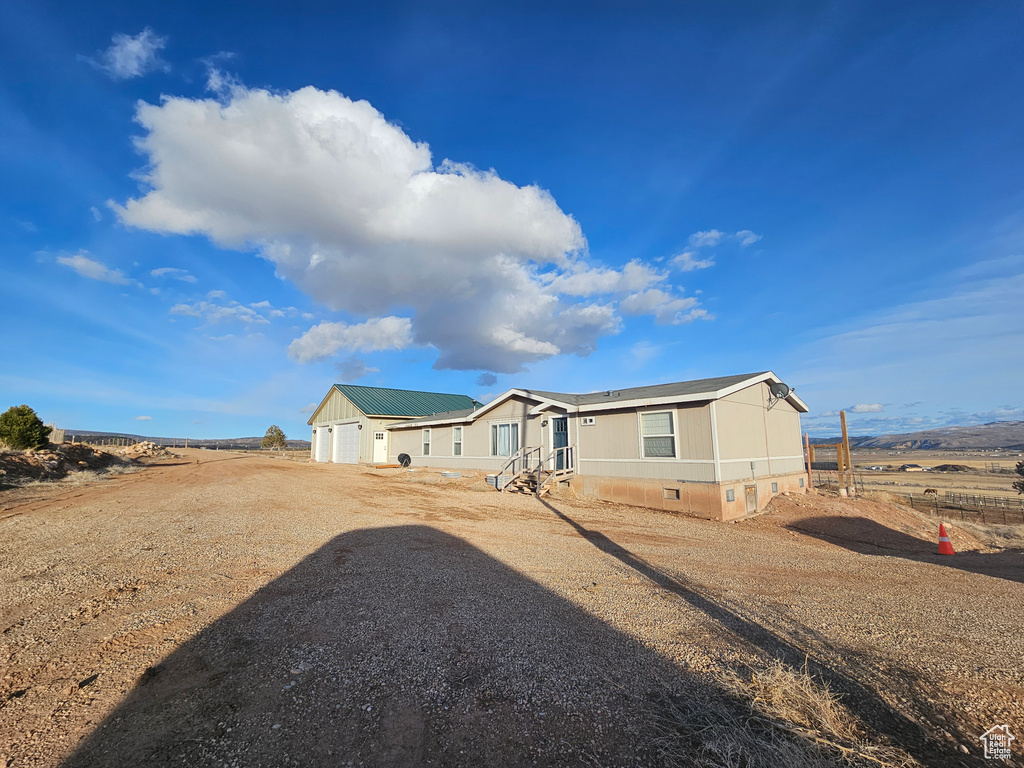 View of front of house featuring driveway, crawl space, and an attached garage