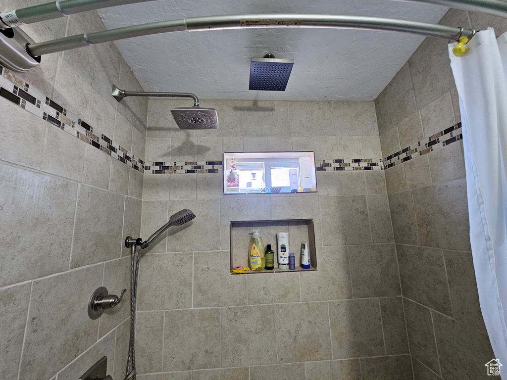 Full bath featuring a tile shower