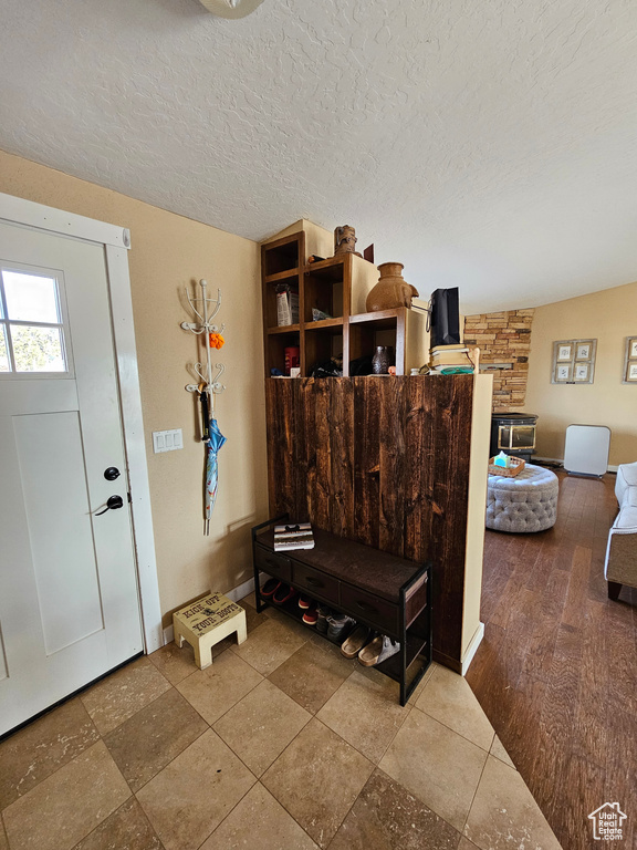 Entrance foyer featuring baseboards and a textured ceiling