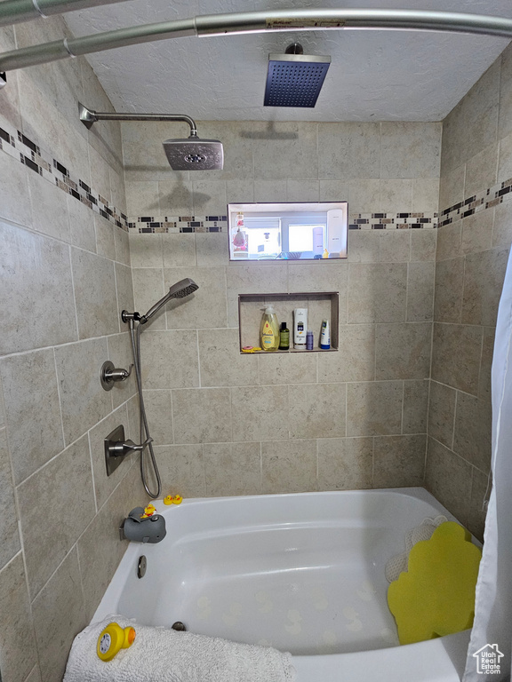 Full bathroom with a combined bath / shower with rainfall shower