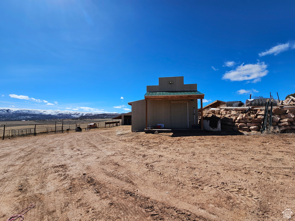 View of yard with a mountain view and fence