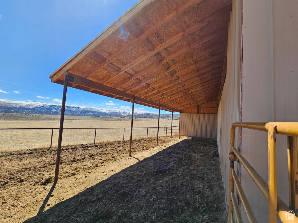 View of yard featuring an exterior structure, an outbuilding, a mountain view, and a rural view