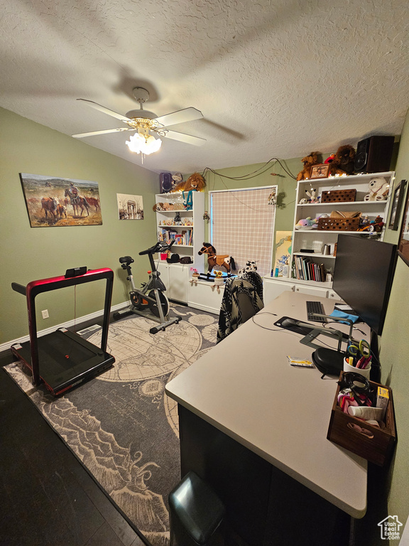 Office featuring a textured ceiling, baseboards, and ceiling fan