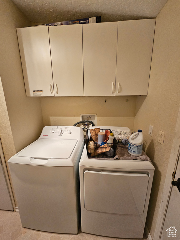 Laundry area featuring cabinet space and washing machine and dryer