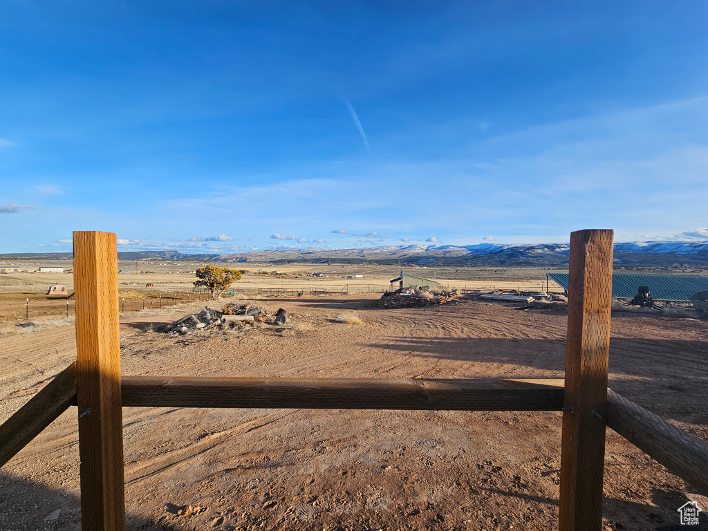View of yard featuring a rural view and a mountain view