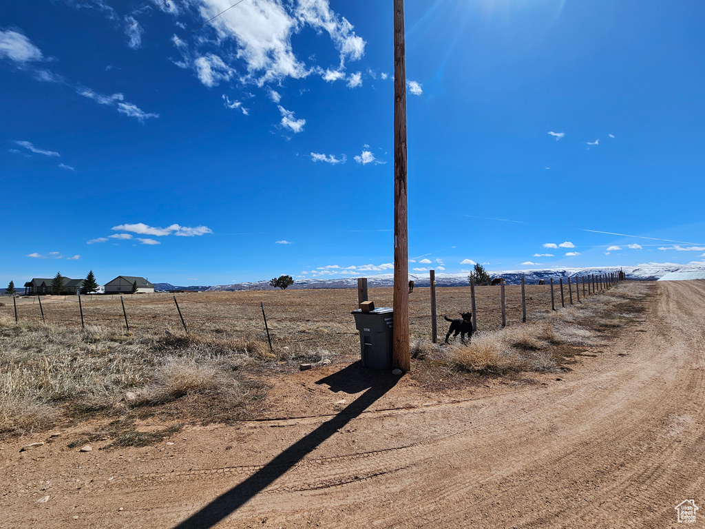 View of yard featuring fence and a rural view