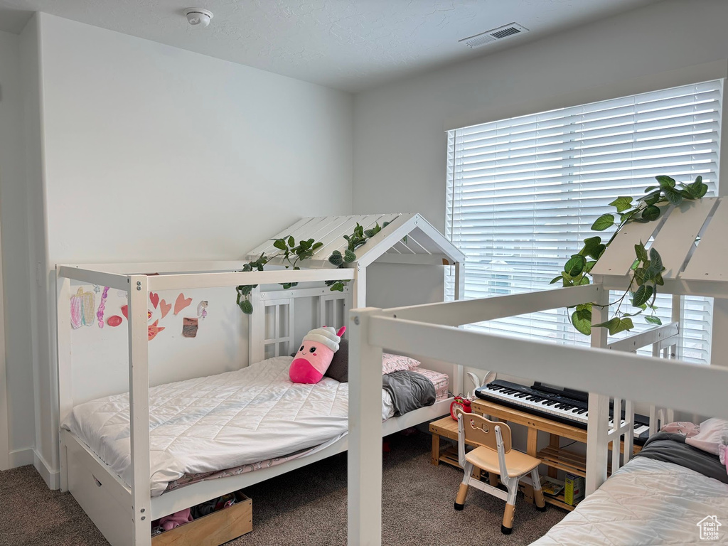 Bedroom with carpet and visible vents
