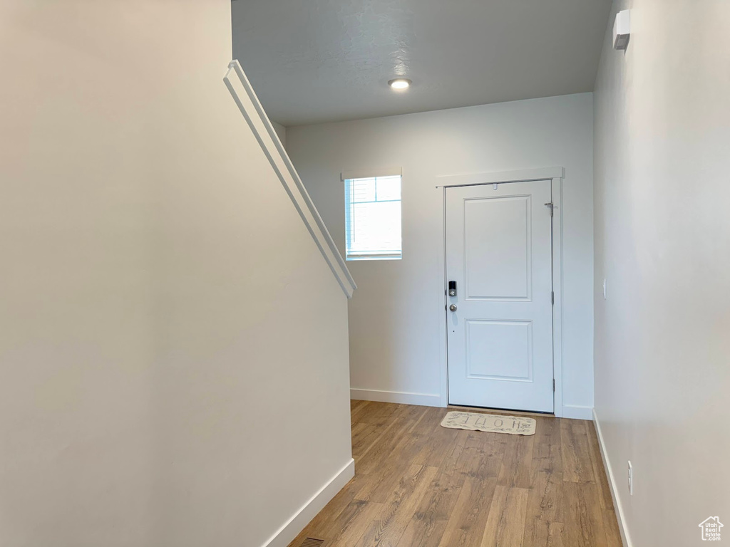 Entrance foyer featuring baseboards and light wood-style flooring