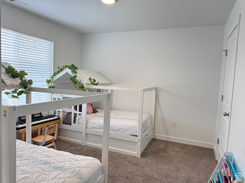 Carpeted bedroom with baseboards