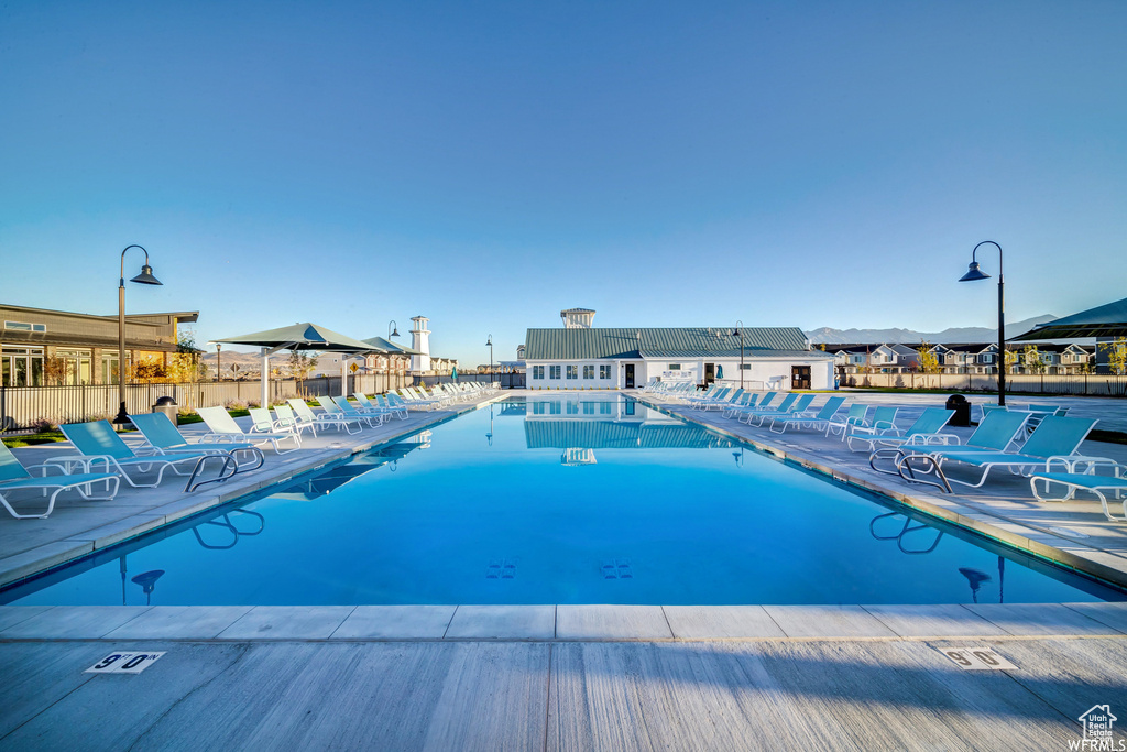 Community pool with fence and a patio area