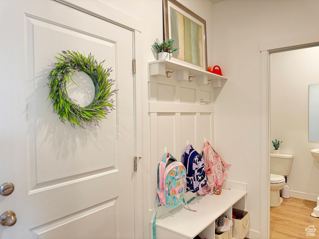 Mudroom with baseboards and wood finished floors