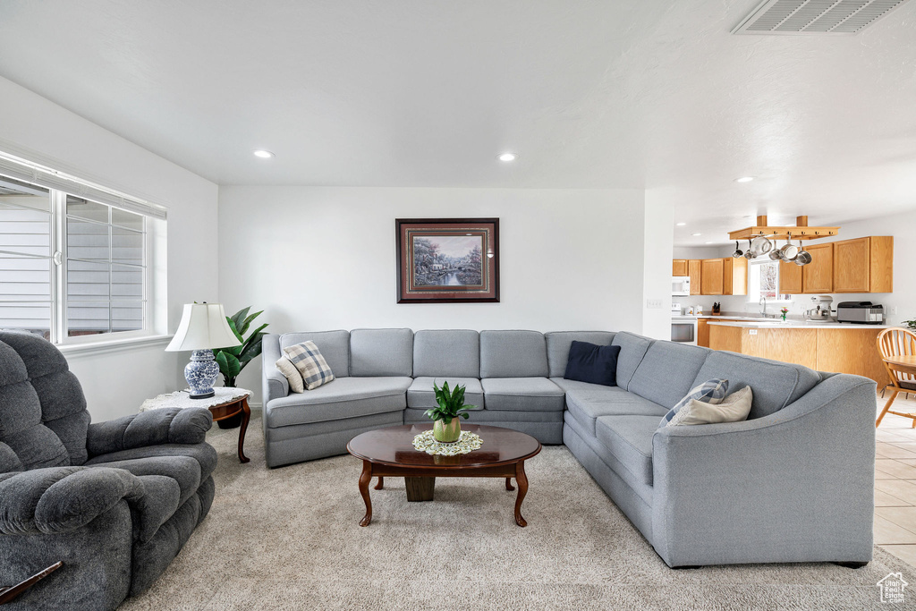 Living room with a toaster, visible vents, recessed lighting, and light tile patterned floors