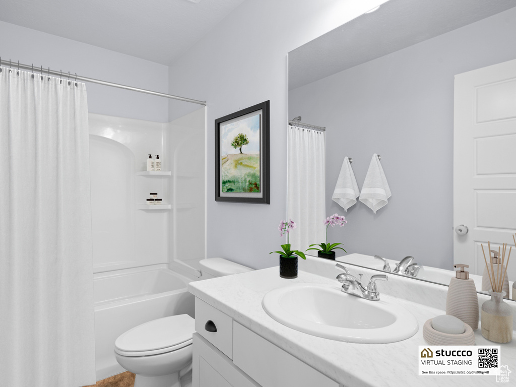 Full bathroom featuring toilet, vanity, and shower / bathtub combination with curtain