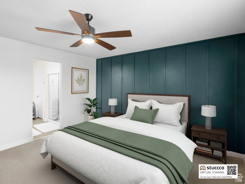 Bedroom featuring a decorative wall, carpet floors, a ceiling fan, and ensuite bathroom