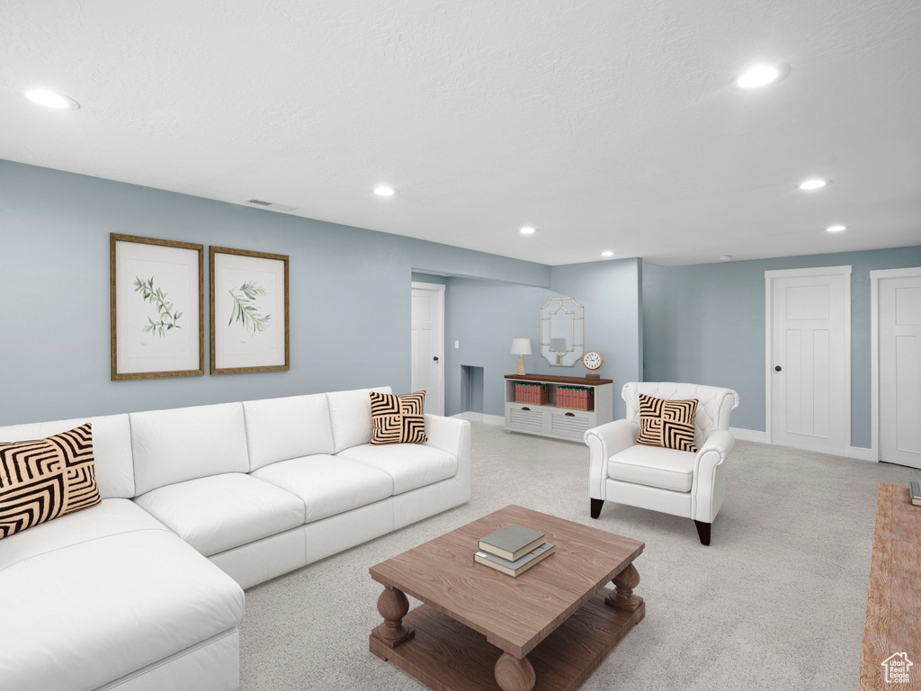 Carpeted living area featuring recessed lighting and baseboards