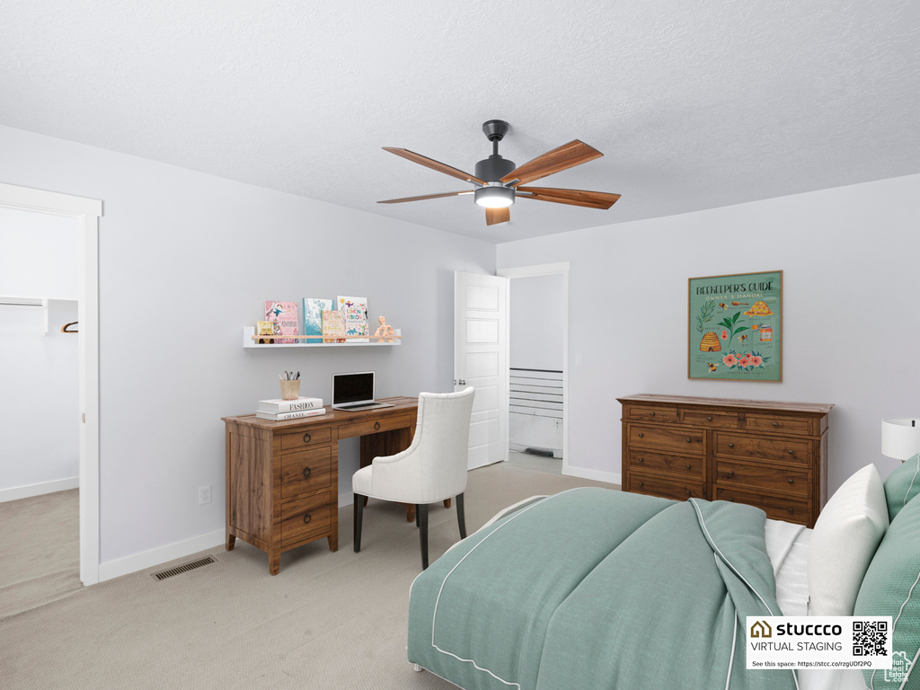 Bedroom with light carpet, baseboards, an office area, and ceiling fan
