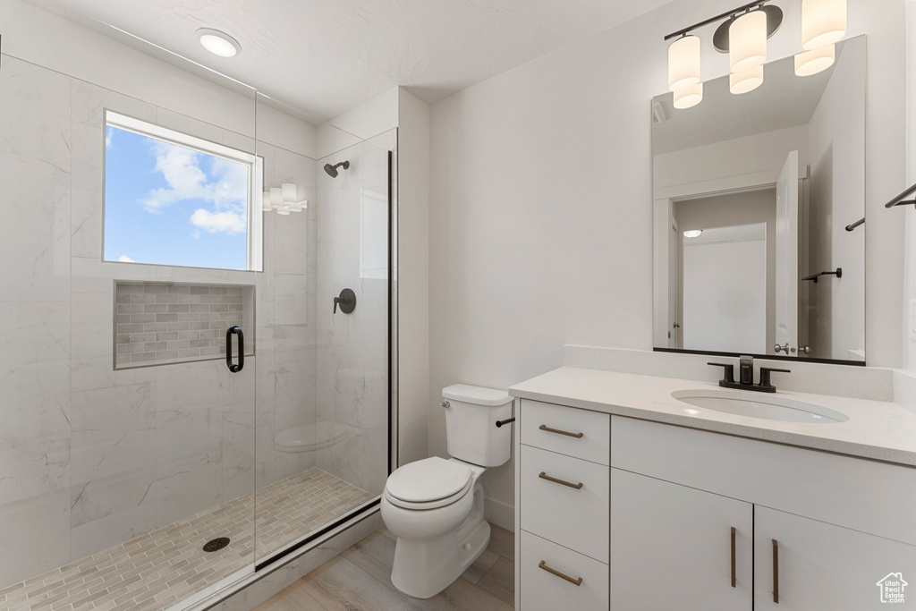 Bathroom with a stall shower and vanity