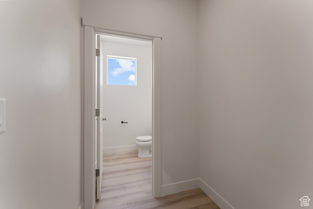 Bathroom featuring toilet and wood finished floors