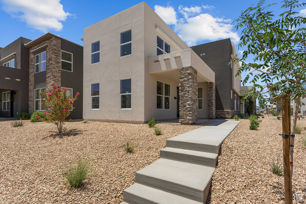 Modern home with stucco siding and stone siding