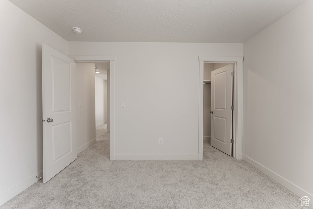 Unfurnished bedroom with carpet floors