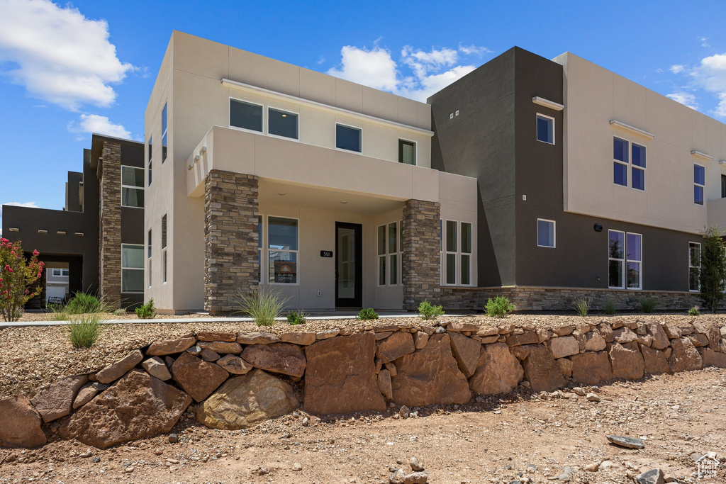 Contemporary home with stone siding and stucco siding