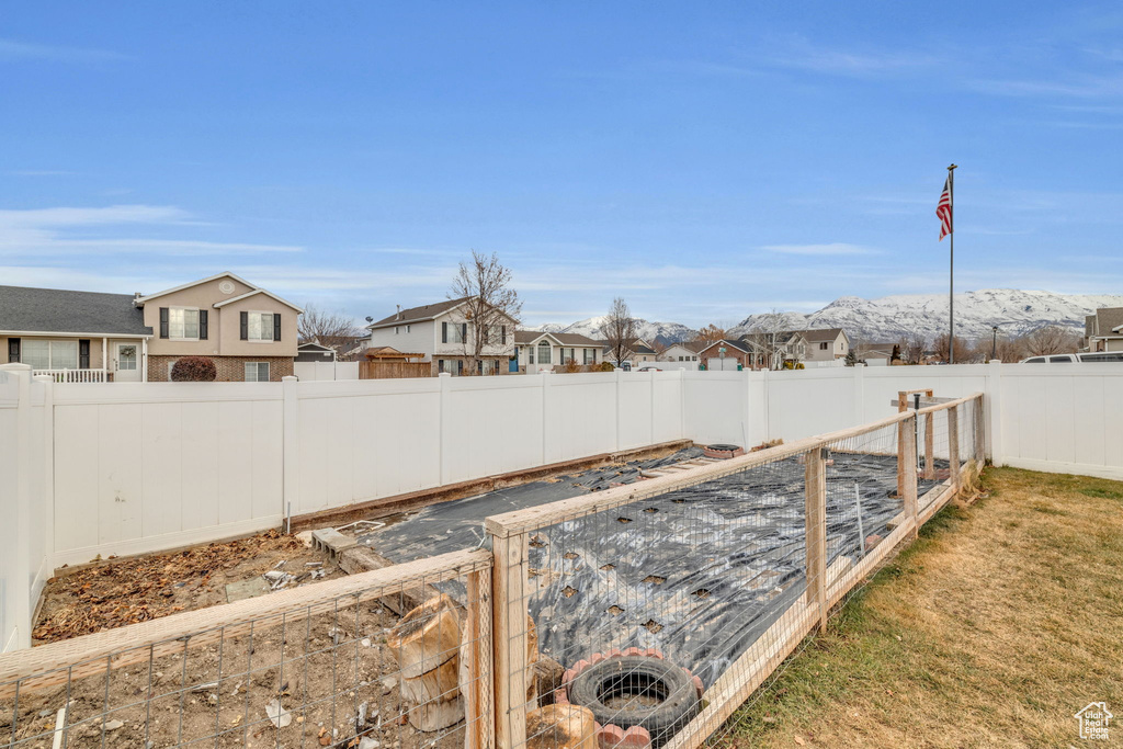 View of yard featuring a garden, a residential view, and a fenced backyard