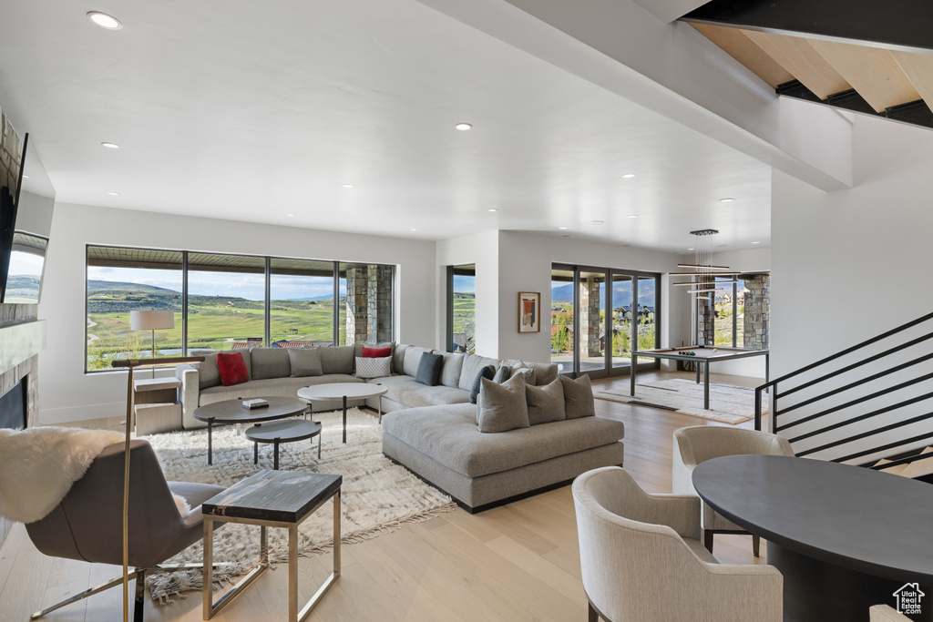 Living room featuring wood finished floors, recessed lighting, and a tile fireplace